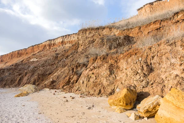 Landslide zone on Black Sea coast. Rock of sea rock shell. Zone of natural disasters during rainy season. Large masses of earth slip along slope of hill, destroy houses. Landslide - threat to lif