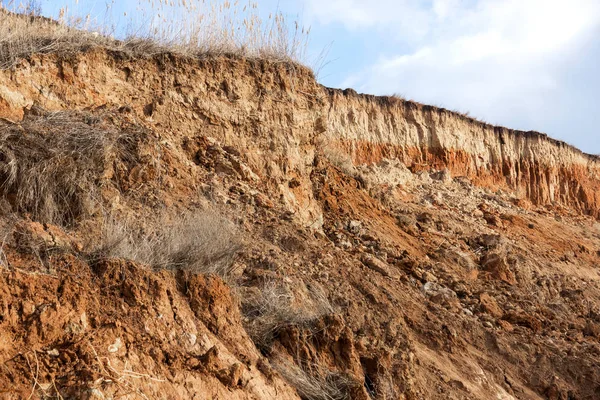 Landslide zone on Black Sea coast. Rock of sea rock shell. Zone of natural disasters during rainy season. Large masses of earth slip along slope of hill, destroy houses. Landslide - threat to lif