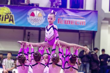 Odessa, Ukrayna - Hazi 16, 2019: Parlak dinamik özellikleri bir destek grubu Bayan spor takımı. Performans destek grubu. Parlak güzel genç kız spor dans formu parkta