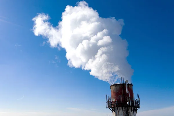 Air pollution, factory pipes, smoke from chimneys on sky background. Concept of industry, ecology, steam plant, heating season, global warming. Factory chimney smoking, smoke emissions from chimneys