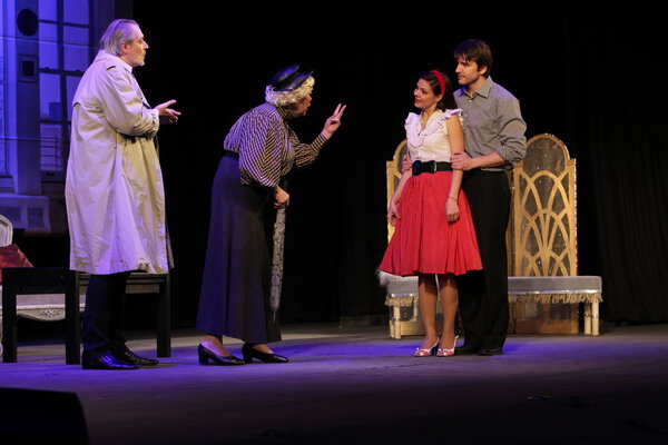 ODESSA, UKRAINE - FEBRUARY 26, 2016: Actors of theater play role of secret lovers in performance of comedy Child for hire. Actors on  theater stage during comedy