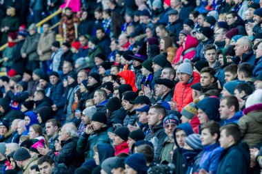 ODESSA, UKRAINE -2 Mart 2019: Shakhtar (Donetsk) maçı sırasında stadyumun tribünlerinde taraftarlar toplandı. Stadyumdaki izleyiciler. Fayer, stadyumun ışıkları yanıyor.