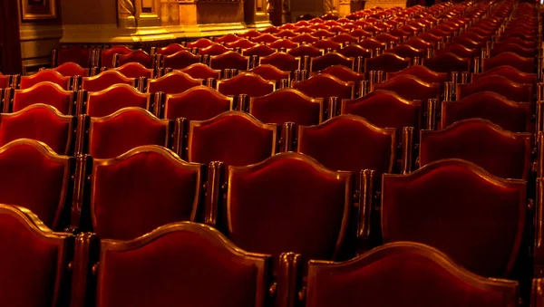 Interior theater art. Audience with empty soft armchairs of Opera and Ballet Theater is waiting for audience. Empty interior of concert theater before performance and without spectators. Soft focus