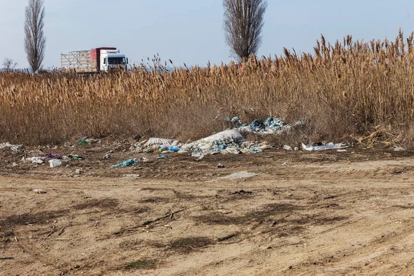 Heaps of trash on road. Road and footpath full of rubbish