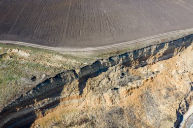 Mountain landslide in an environmentally hazardous area. Large crack in ground, descent of large layers of dirt. Deadly danger at foot of landslide mountain. Soil erosion Avalanche. Steep coast, crack clipart