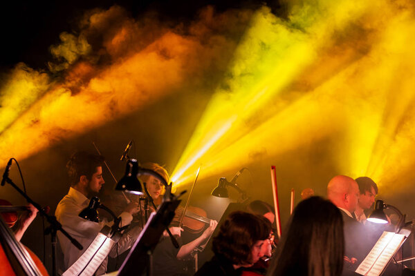 ODESSA, UKRAINE - March 23, 2019: Symphony orchestra concert on theater stage. Musicians of State Symphony Orchestra, instruments of symphony orchestra on stage. Score, sheet music during concert