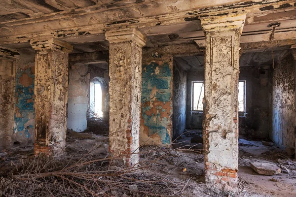 Mystical interior, ruins of an abandoned ruined building of house of culture, theater of USSR. Old destroyed walls, corridor with garbage and dirt. Destroyed molding, plaster ornaments, bas-relief