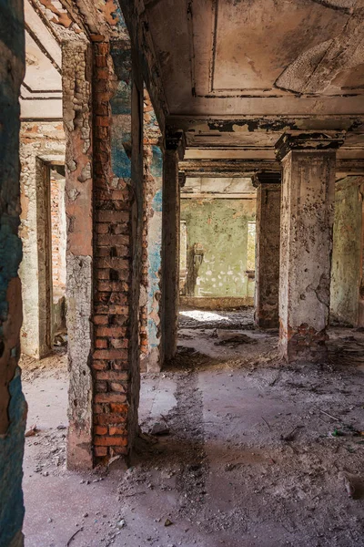 Mystical interior, ruins of an abandoned ruined building of house of culture, theater of USSR. Old destroyed walls, corridor with garbage and dirt. Destroyed molding, plaster ornaments, bas-relief