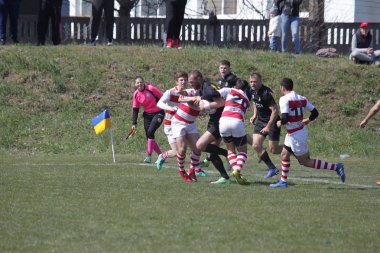 Odessa, Ukrayna - 6 Nisan 2019: Milli takım amentü (Odessa)-Olimpiyat (Kharkov) Rugby Şampiyonası. Gergin mücadele oyuncu topu için rugby testi sırasında. Stadyum yeşil alan üzerinde dinamik oyun