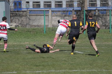 Odessa, Ukrayna - 6 Nisan 2019: Milli takım amentü (Odessa)-Olimpiyat (Kharkov) Rugby Şampiyonası. Gergin mücadele oyuncu topu için rugby testi sırasında. Stadyum yeşil alan üzerinde dinamik oyun