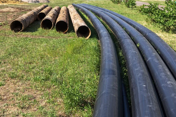 Replacement of old rusted broken metal water pipes with modern plastic pipes. Plastic pipes ready to replace after many years of operation destroyed by corrosion and rust metal pipe was destroyed