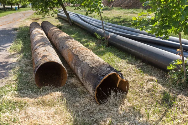 Replacement of old rusted broken metal water pipes with modern plastic pipes. Plastic pipes ready to replace after many years of operation destroyed by corrosion and rust metal pipe was destroyed