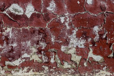 Alçı tuğla duvarın boş eski sanat dokusu. Yaprak dokusuyla boyanmış taş tuğla duvarın çatlaklarıyla kötü çizilmiş yüzey. Hasarlı alçıyla binanın ön cephesini ovaladım.