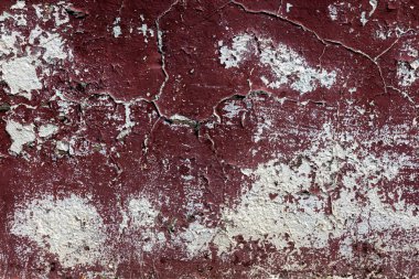 Alçı tuğla duvarın boş eski sanat dokusu. Yaprak dokusuyla boyanmış taş tuğla duvarın çatlaklarıyla kötü çizilmiş yüzey. Hasarlı alçıyla binanın ön cephesini ovaladım.