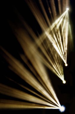 Sahne ışıkları. Karanlıkta birkaç projektör var. Gösteri sırasında sahnenin sahne ışıklarından gelen çok renkli ışık demetleri sahnenin dumanının içinde. Gece kulübü. Işıklar açık. Lazer gösterisi