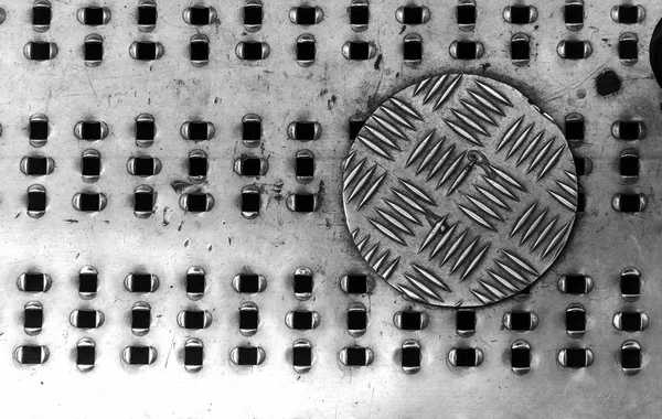 Grunge metal background or texture with scratches and cracks. Background metal surface made of stainless steel. Old, dirty scratched stainless steel floor plate texture. Free space. Selective focus