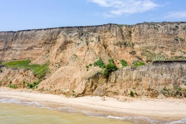 Landslide zone on Black Sea coast. Rock of sea rock shell. Zone of natural disasters during rainy season. Large masses of earth slip along slope of hill, destroy houses. Landslide - threat to life