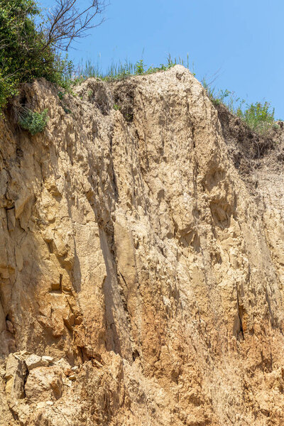 Landslide zone on Black Sea coast. Rock of sea rock shell. Zone of natural disasters during rainy season. Large masses of earth slip along slope of hill, destroy houses. Landslide - threat to life