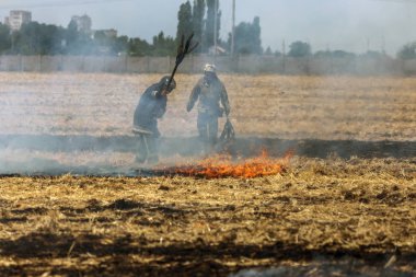 Odessa, Ukrayna - Cirka 2019: Surging Step Yangınları. Tahıl koşum saman ve saman hasat sonra sahada. Ekolojik felaket. Ateş ve duman tüm yaşamı yok eder. İtfaiyeciler Büyük Yangını söndürür. Çok duman
