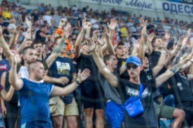 Odak dışında, keskin spor arka plan değil - stadyumda seyirci. Maç sırasında futbol stadyumu tribünlerinde taraftarlar tribünlerde taraftarlar la Tribune. Futbol taraftarları ile standları