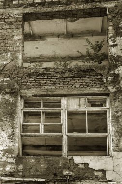 Terk edilmiş bir binanın eski camı kırıldı. Büyük cam çatlakları ile taraflı bir binada harap bir pencere