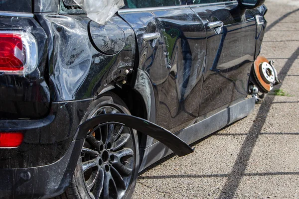 The body of the car is damaged as a result of an accident. High speed head on a car  traffic accident. Dents on the car body after a collision on the highway