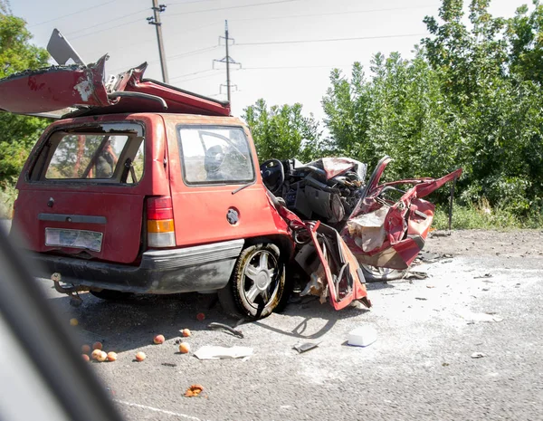 The body of the car is damaged as a result of an accident. High speed head on a car  traffic accident. Dents on the car body after a collision on the highway