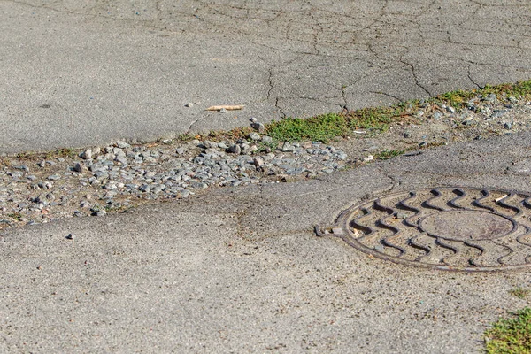 Old and cracked road surfaces are used to create the background and design. Deep relief Cracks on the pavement. Worn road, very used or broken by the weather