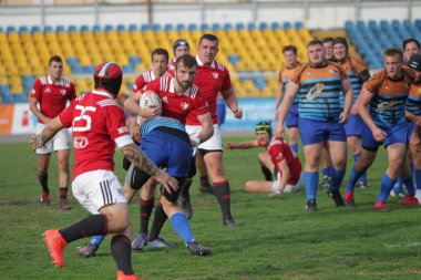 Odessa, Ukrayna - 29 Eylül 2019: Odessa ragbi takımı - Kiev Politeknik. Rugby oyuncularının top için yoğun mücadelesi. Stadyumun yeşil sahasında dinamik bir oyun. Vahşi Rugby Dövüşü