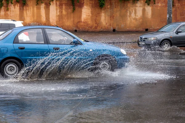 ウクライナのオデッサ 2020年5月28日 豪雨による洪水時の浸水した道路上で車を運転する 車の水には 洪水の通りに浮かぶ 車の上でスプラッシュ 大規模な水たまりと洪水都市道路 — ストック写真