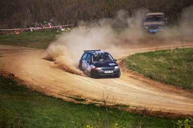 ODESSA, UKRAINE - 30 Nisan 2017: Geleneksel ralli Autocross Şampiyonası. Yarış arabası tehlikeli. Dik bir yarış pistine giriyor, etrafa saçılıyor, toz püskürtüyor. Aşırı ralli otomobili