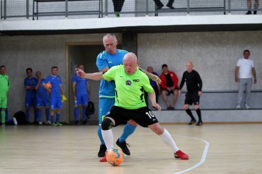 Odessa, Ukrayna - 29 Mayıs 2020: 50 + gaziler arasında futsal kupa play-off maçı. Futsal, spor salonunun büyük sahnesinde, modern oyun alanını kapsıyor. Koridorda yoğun bir mini futbol maçı var. Parke üzerinde