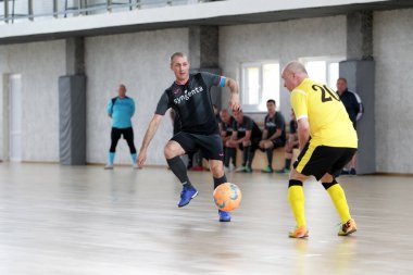Odessa, Ukrayna - 29 Mayıs 2020: 50 + gaziler arasında futsal kupa play-off maçı. Futsal, spor salonunun büyük sahnesinde, modern oyun alanını kapsıyor. Koridorda yoğun bir mini futbol maçı var. Parke üzerinde