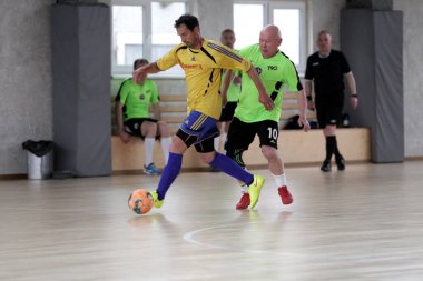 Odessa, Ukrayna - 29 Mayıs 2020: 50 + gaziler arasında futsal kupa play-off maçı. Futsal, spor salonunun büyük sahnesinde, modern oyun alanını kapsıyor. Koridorda yoğun bir mini futbol maçı var. Parke üzerinde
