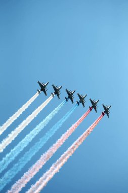 MOSCOW, RUSSIA - June 24, 2020: Victory Parade -75. Red Square. Aerial show in sky. Air parade Russian aviation. Su-25 in sky forces Russian tricolor smoke flag during military parade on Victory Day clipart