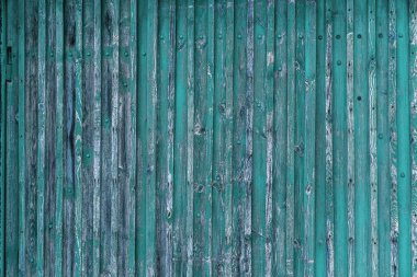 Eski boyalı ahşabın soyut arkaplanı. Ahşap yüzey üzerinde eski kırık boya izleri olan tahta çitler.