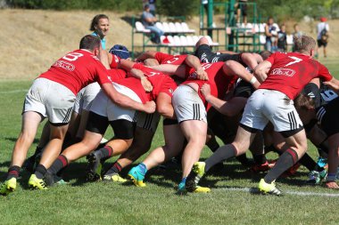 Odessa, Ukrayna - 29 Ağustos 2020: Odessa Milli Takımı CREDO (kırmızı) - Kiev Antares (siyah) ragbi 7 'leri. Top için erkek rugby oyuncularının sert agresif dövüşü. Stadyumun yeşil çimenlik alanında dinamik bir oyun