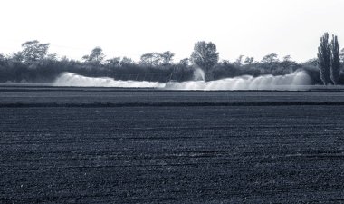 Otomatik tarım sulama sistemi, tarımın kurak bölgesindeki tarlaların sulanması. Uzun bir fıskiye hattı tohum tarlasını suluyor. Tarım endüstrisi, kuru arazi tarımı