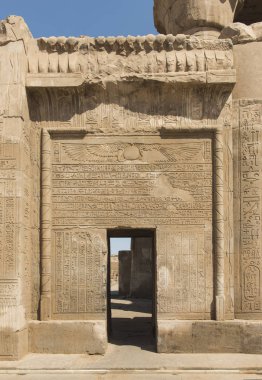 Hieroglypic carvings on wall at the entrance to ancient egyptian temple of Kom Ombo clipart