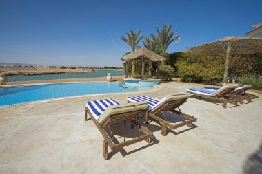Lüks villa gösterisinde eve tropikal yaz tatili resort havuz ve güneş sandalyeler
