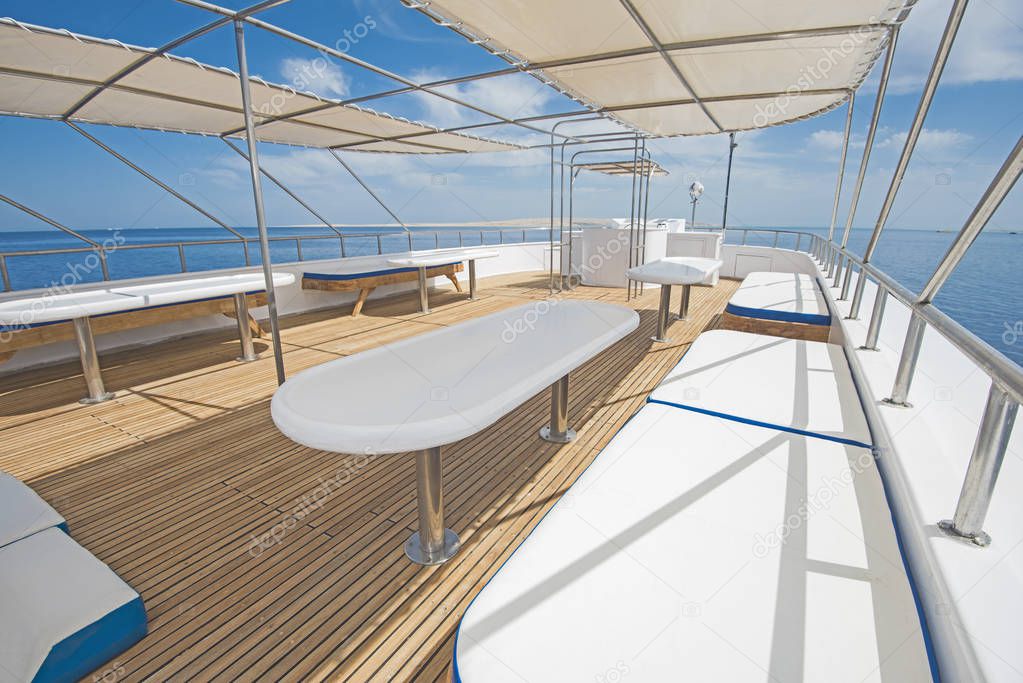 Table and chairs on sundeck of a luxury motor yacht
