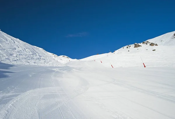 View up a piste in alpine ski resort — Stock Photo, Image