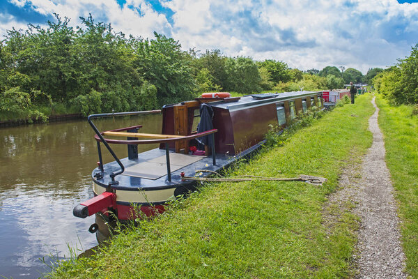Narrowboat on a British canal in rural setting