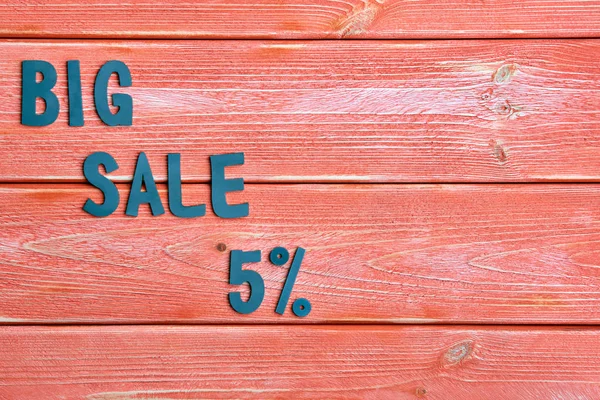 big sale lettering and discount offer at 5 percent, metal letters on textured wooden boards color season 2019, close up, top view, flat lay