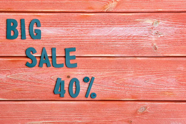 big sale lettering and discount offer at 40 percent, metal letters on textured wooden boards color season 2019, close up, top view, flat lay