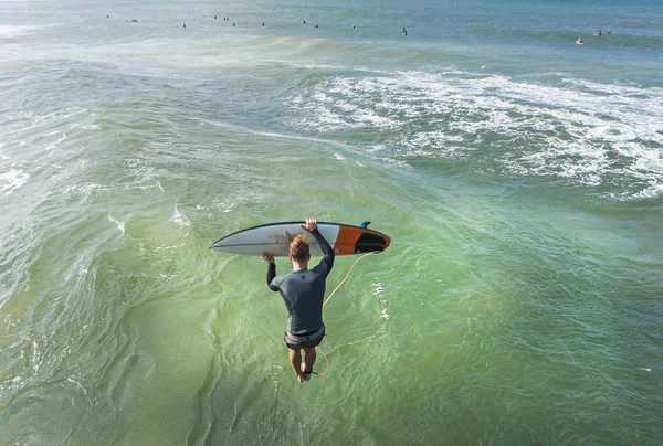 surfer jumping in the ocean