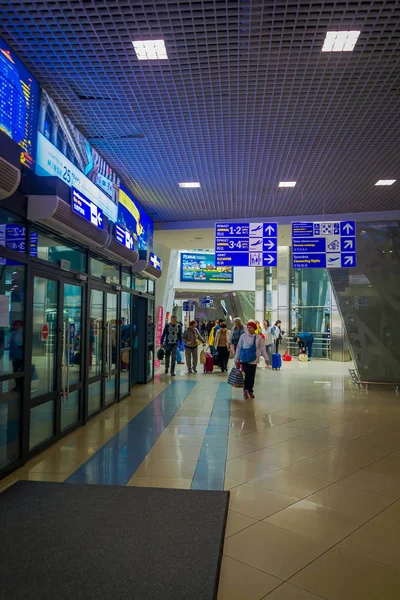 Minsk, Bělorusko - 01 květen 2018: Vnitřní pohled neznámých lidí, kteří jdou za informativní značka uvnitř mezinárodní letiště Minsk — Stock fotografie