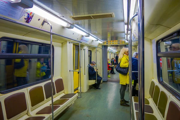 MOSCOW, RUSSIA- APRIL, 29, 2018: People inside of metro, perspective view to Contemporary spacious interior and comfortable seats of modern train moving fast inside urban metro tunnel — Stock Photo, Image