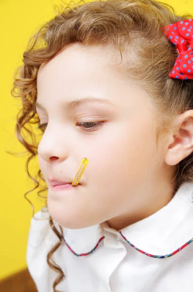 Portrait of little curly girl with thermometer into mouth — Stock Photo, Image