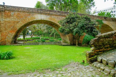 Outdoor view of brick bridge of Humilladero located in the forest surrounding of nature in colonial city Popayan clipart
